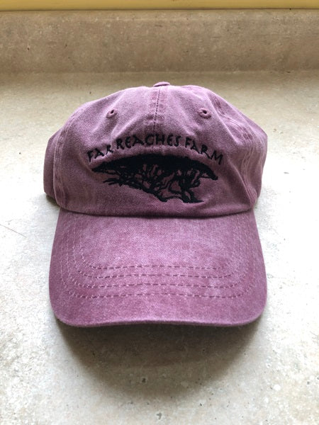 A dark maroon hat with the Far Reaches Farm logo